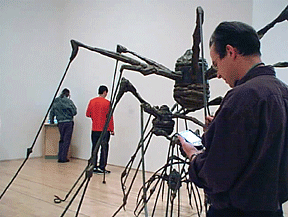 Figure 13: Visitor learning about Louise Bourgeois via the handheld IPAQ