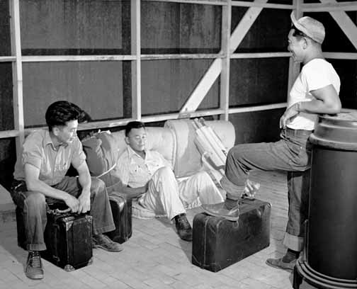 Figure 1: Three young evacuees drop their baggage and relax to argue about whose bunk goes in which corner on arriving at their new quarters. Courtesy of the Colorado Historical Society, F32,640